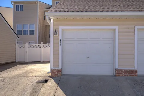 an empty room with wooden floor closet and windows