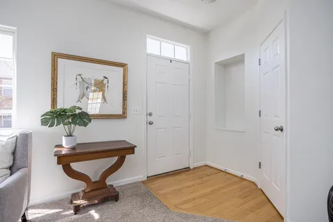 a view of a livingroom with furniture and a potted plant