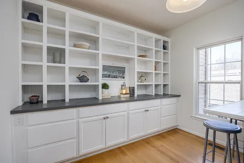 a kitchen with white cabinets and white appliances
