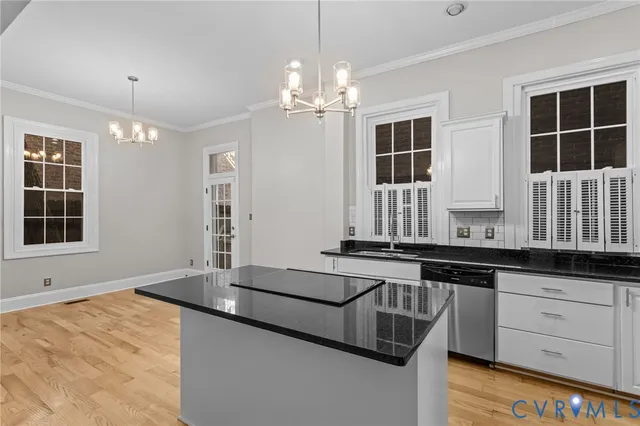 a kitchen with granite countertop a stove a sink and dishwasher