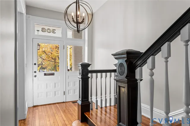 a view of a hallway with wooden floor and windows