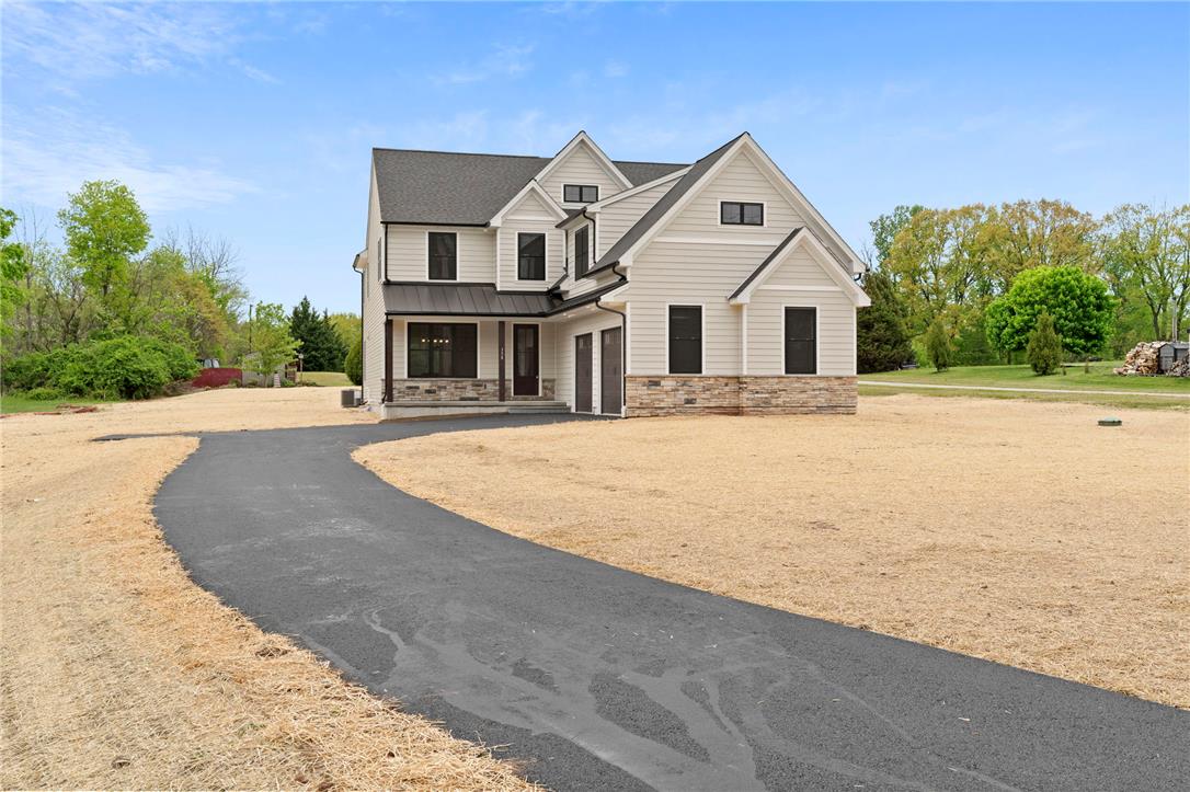 Hottle Road Quakertown, PA 18951 - Photo 5 of 59 A long paved driveway leads to a modern two-story home with stone accents.
