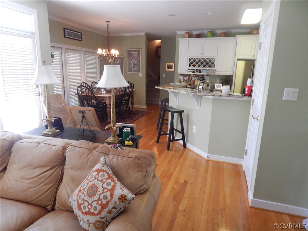 1737 Rolfield Way Henrico, VA 23238 - Photo 2 of 16 a living room with furniture and a chandelier
