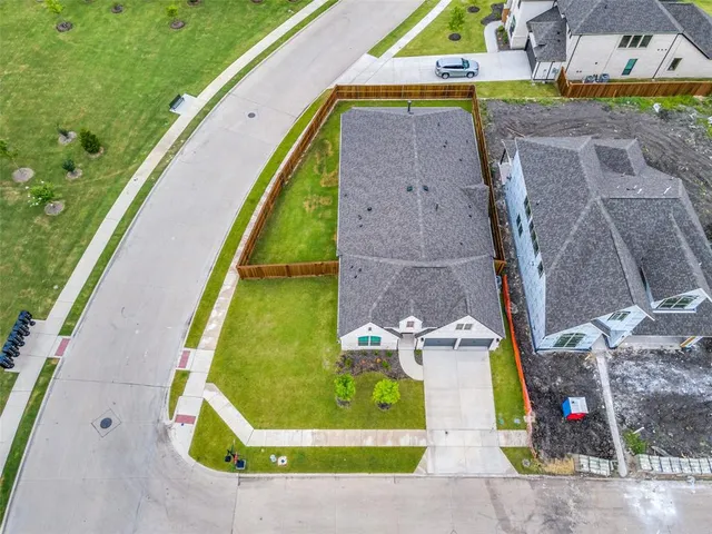 an aerial view of a house with a swimming pool