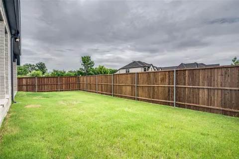 a view of a backyard with a fence