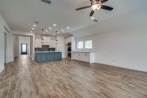 a view of kitchen and hall with wooden floor