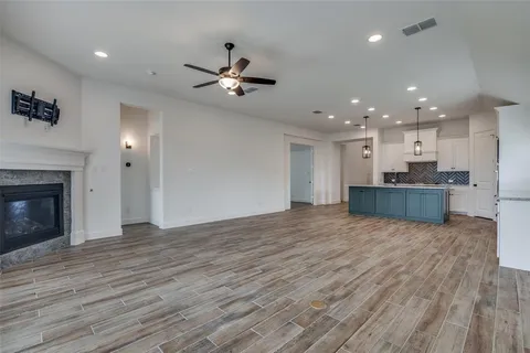 a view of a kitchen with a dishwasher and a fireplace