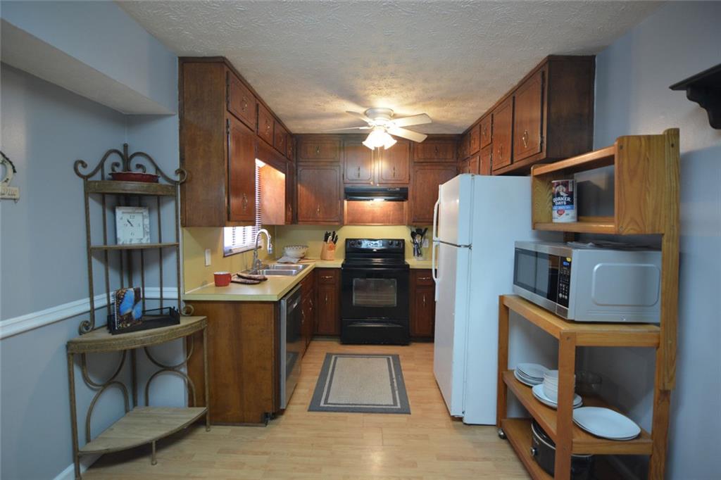 692 Davis Road Lawrenceville, GA 30046 - Photo 8 of 36 a kitchen with stainless steel appliances granite countertop a refrigerator a stove and a sink