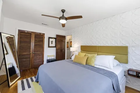 a bedroom with a bed and a flat screen tv
