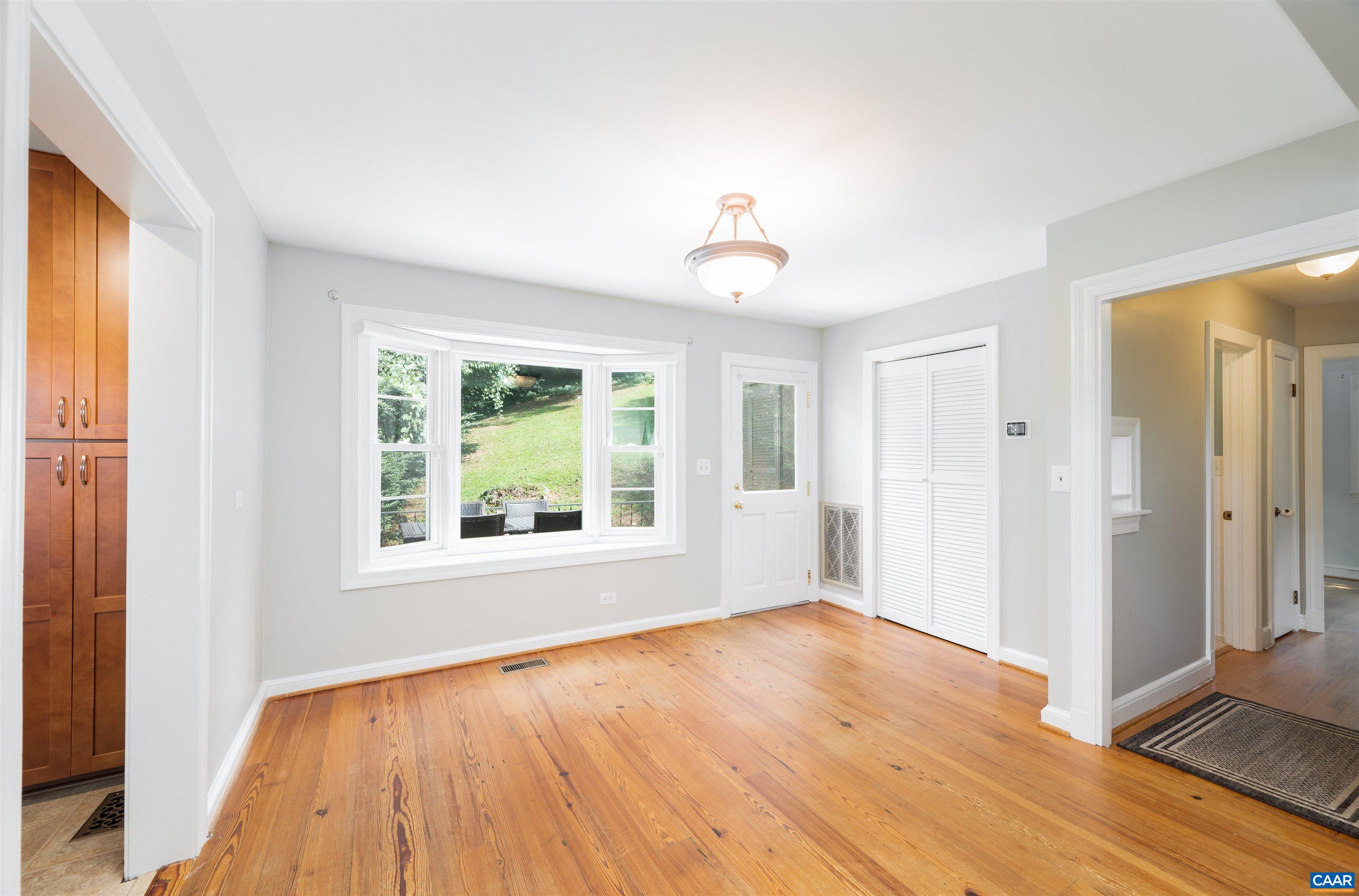 103 Perry Drive Charlottesville, VA 22902 - Photo 12 of 37 an empty room with wooden floor and windows