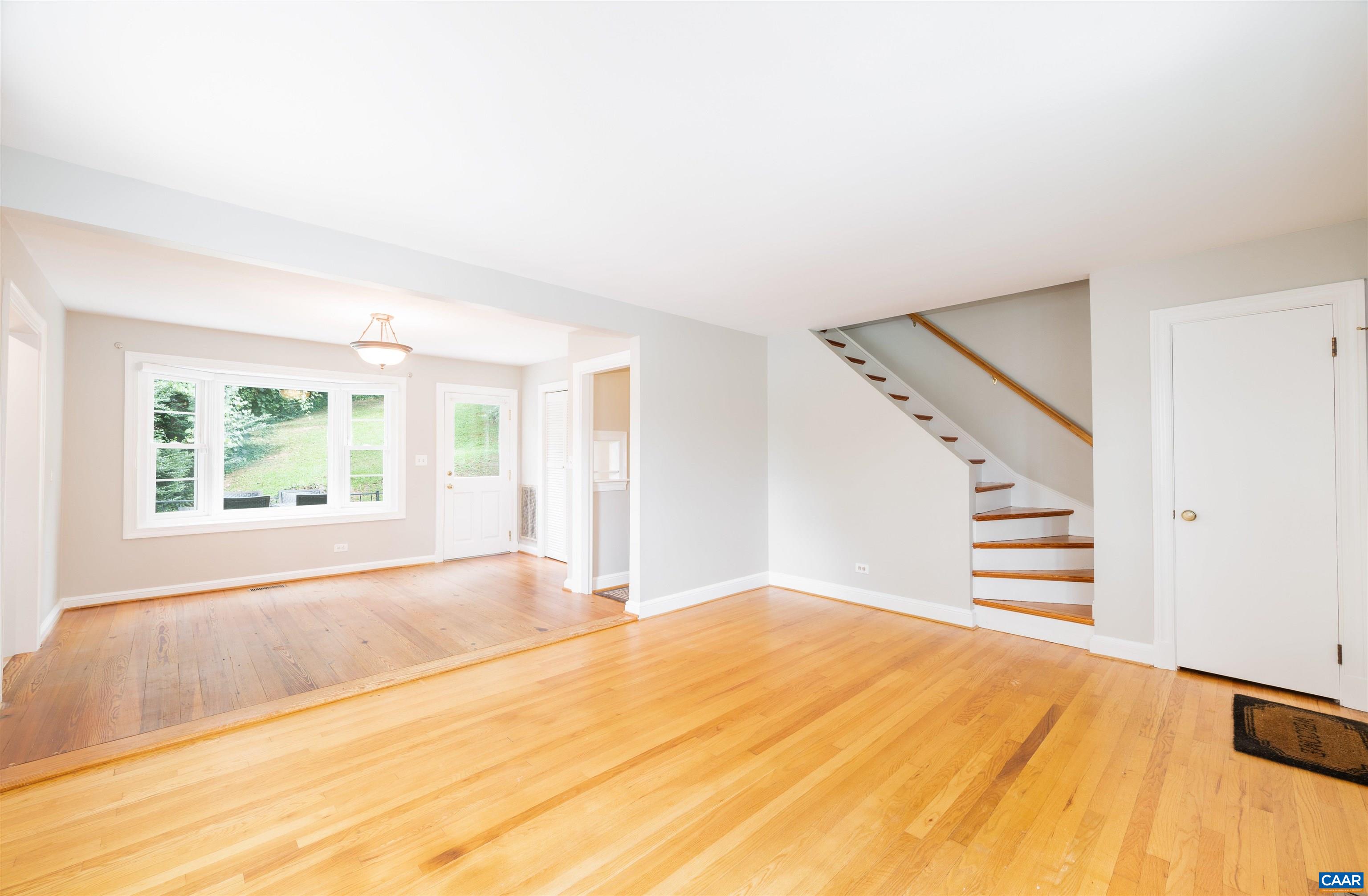 103 Perry Drive Charlottesville, VA 22902 - Photo 3 of 37 a view of empty room with wooden floor and fan