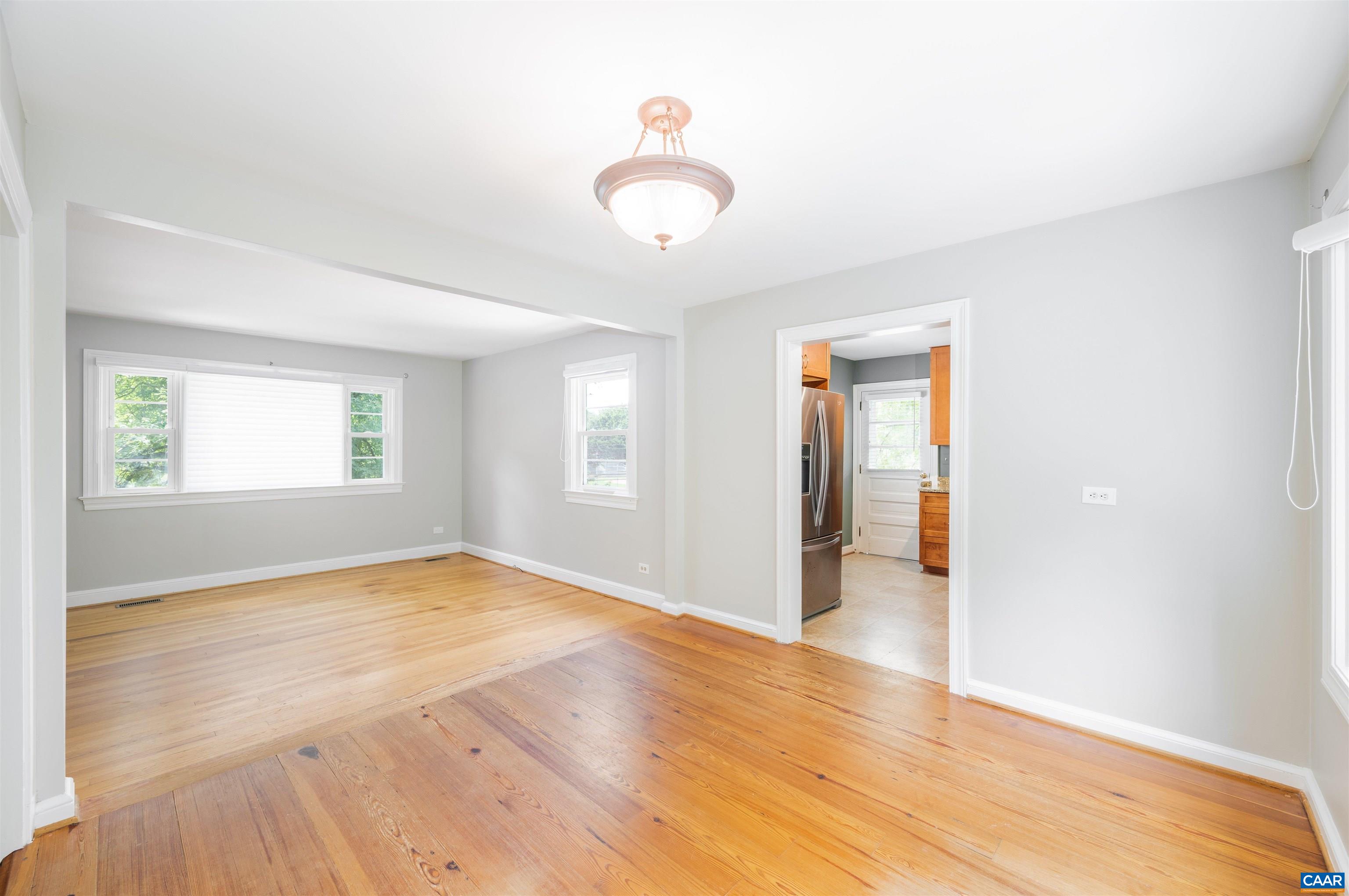 103 Perry Drive Charlottesville, VA 22902 - Photo 4 of 37 an empty room with wooden floor and windows