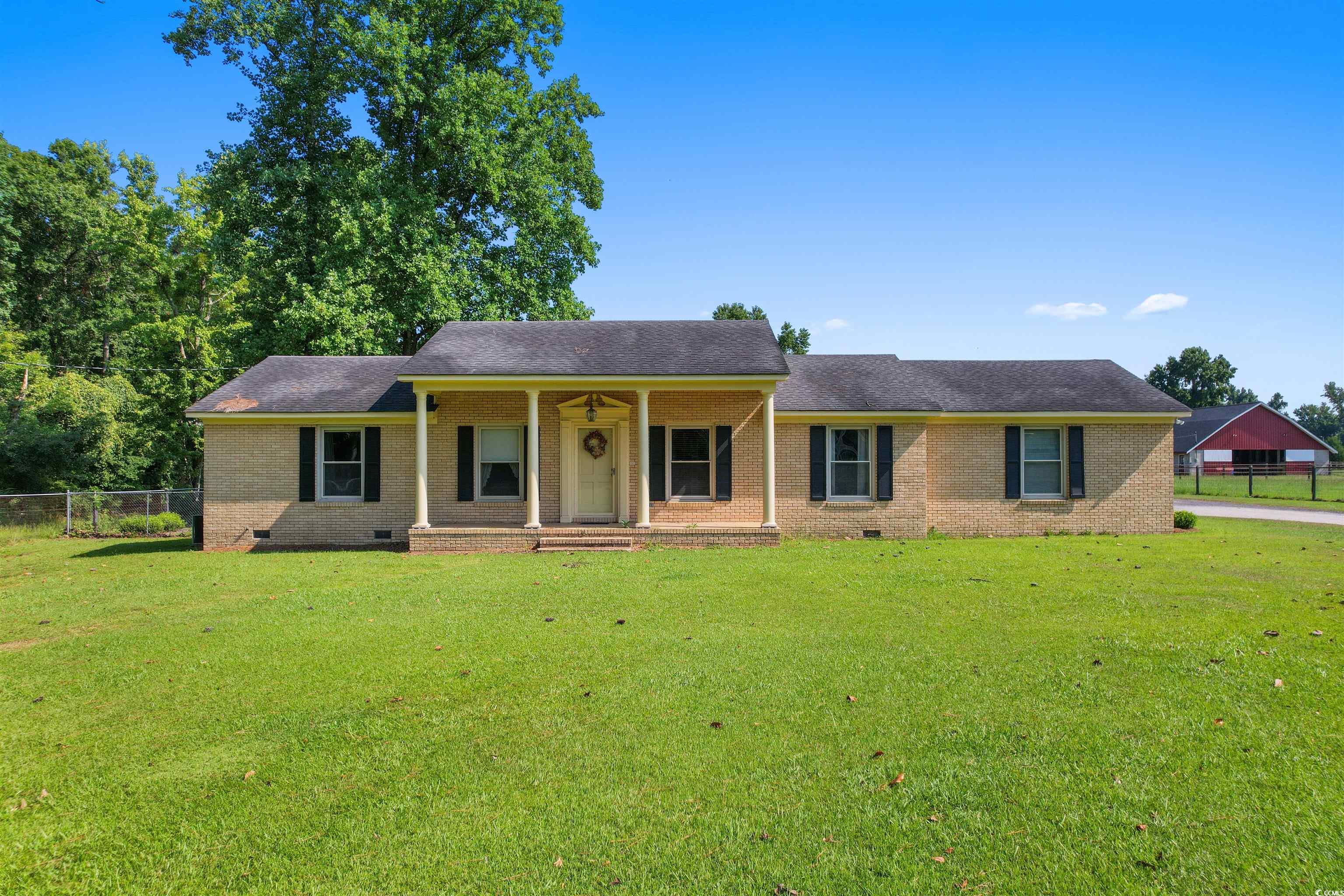 3101 Willow Creek Road Florence, SC 29505 - Photo 11 of 39 Single story home with fence, crawl space, brick siding, a front lawn, and a porch