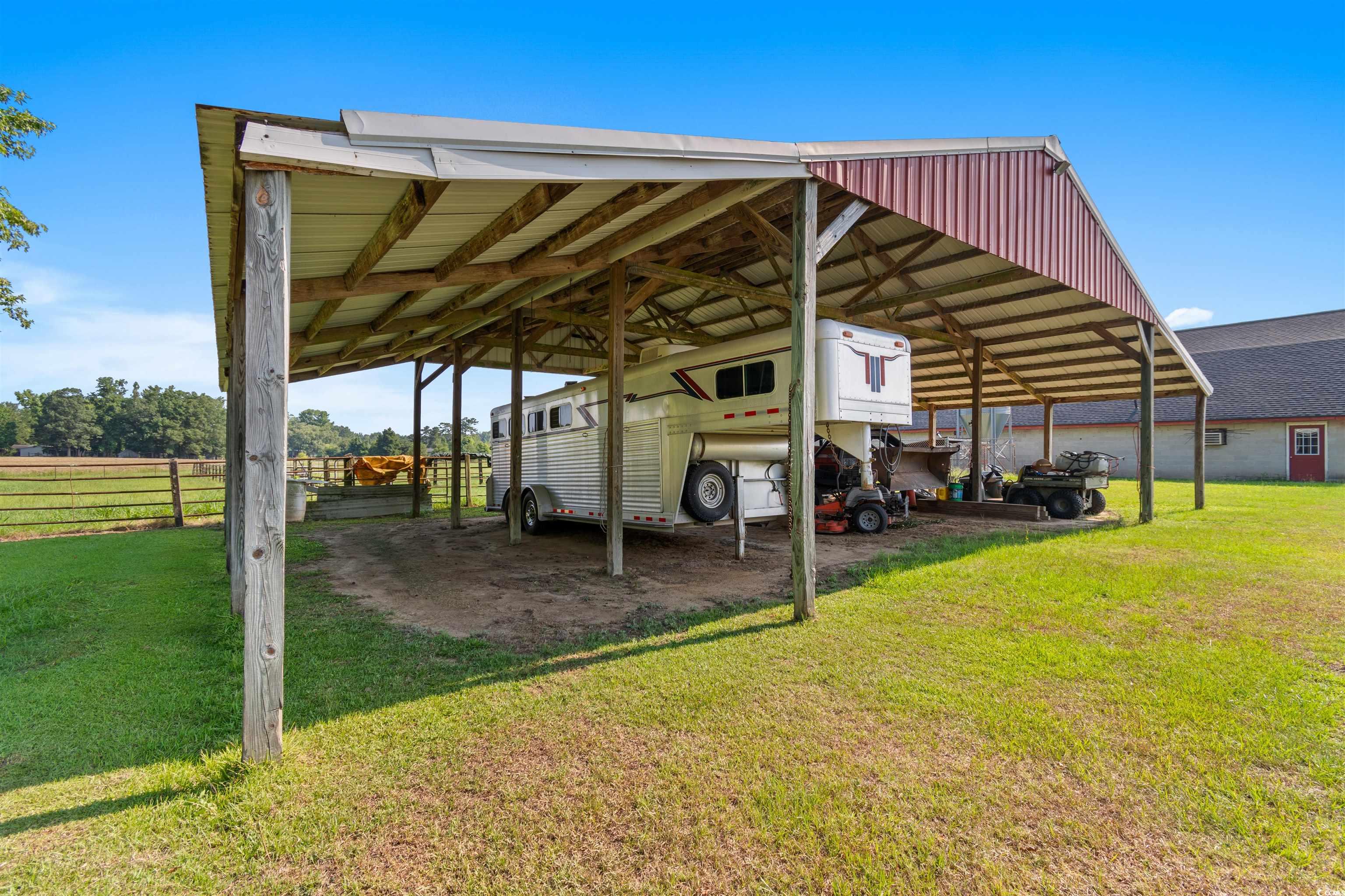 3101 Willow Creek Road Florence, SC 29505 - Photo 13 of 39 View of parking / parking lot featuring fence and a carport