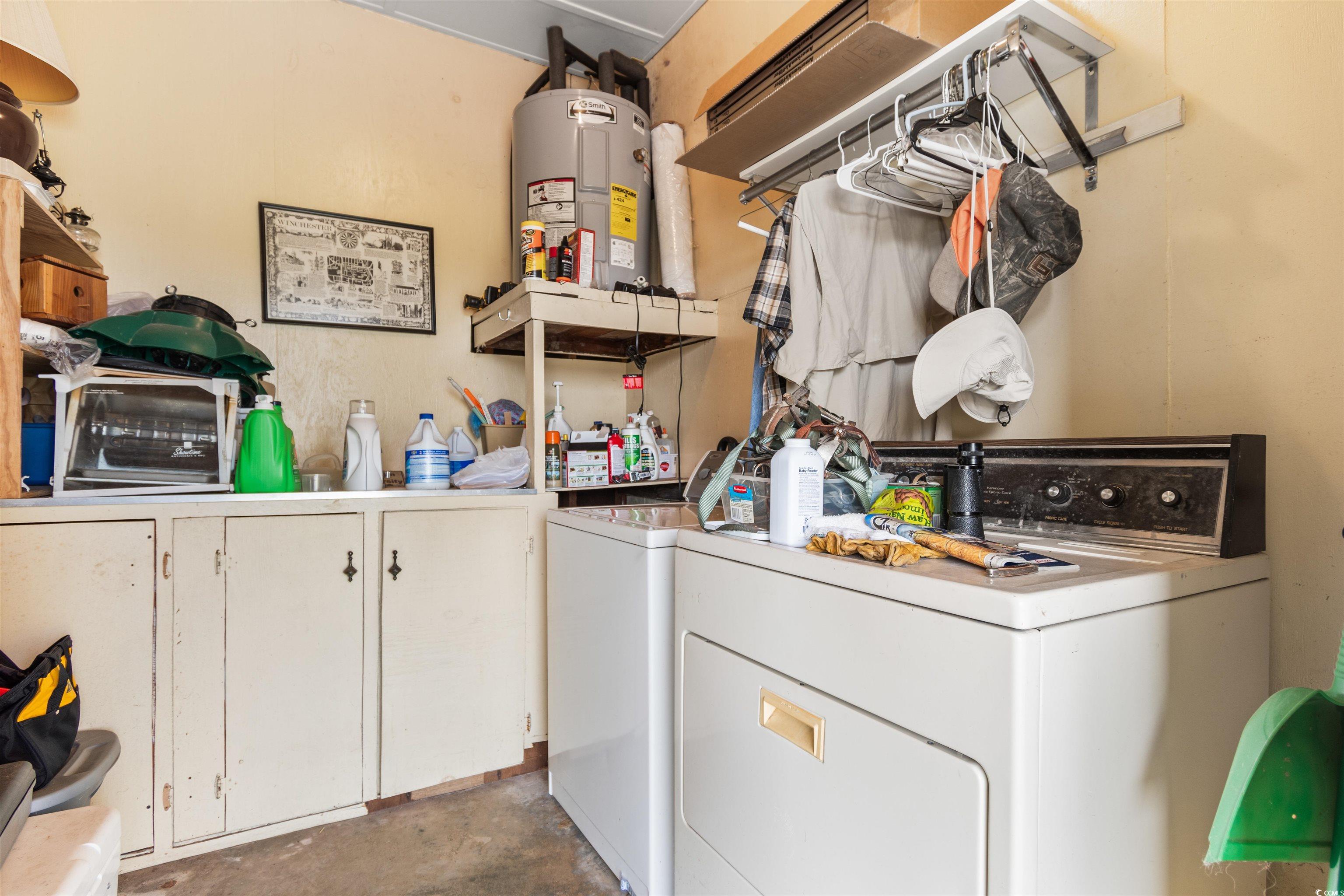 3101 Willow Creek Road Florence, SC 29505 - Photo 14 of 39 Laundry area with cabinet space, washer and clothes dryer, and electric water heater