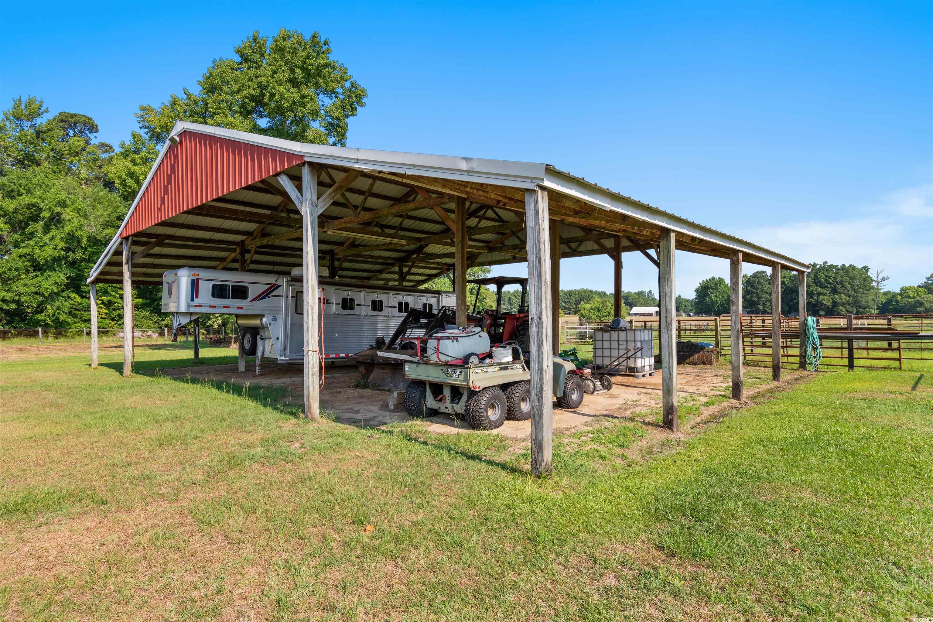 3101 Willow Creek Road Florence, SC 29505 - Photo 19 of 39 View of pole building with a lawn, a detached carport, and fence