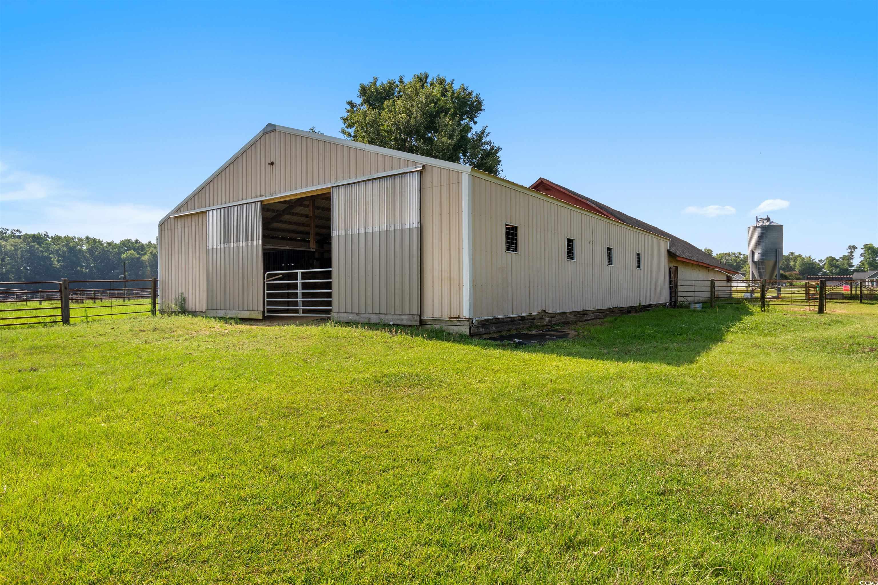 3101 Willow Creek Road Florence, SC 29505 - Photo 5 of 39 View of pole building featuring fence, an exterior structure, and a yard