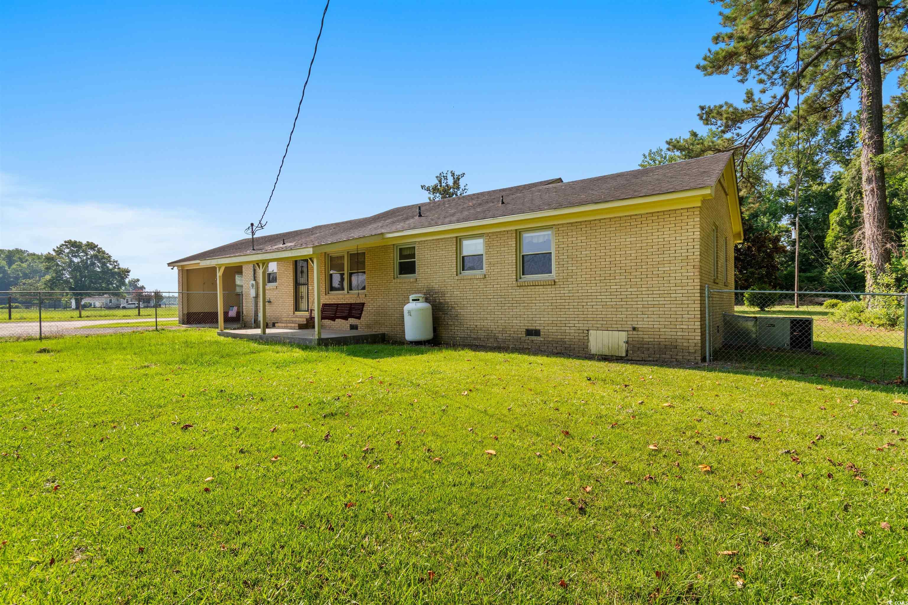 3101 Willow Creek Road Florence, SC 29505 - Photo 9 of 39 Rear view of property with brick siding, fence, crawl space, and a yard