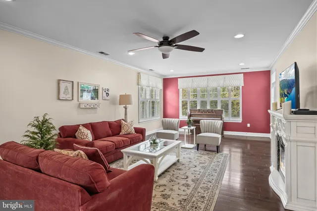 a living room with furniture ceiling fan and a rug