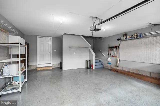 an empty room with stairs and white walls