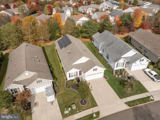 an aerial view of a residential apartment building with a yard