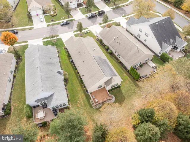 an aerial view of a house with a yard and trees