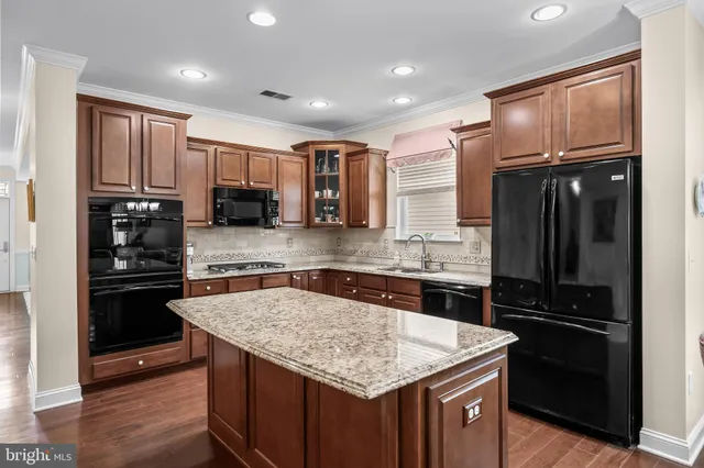 a kitchen with a sink stove and refrigerator