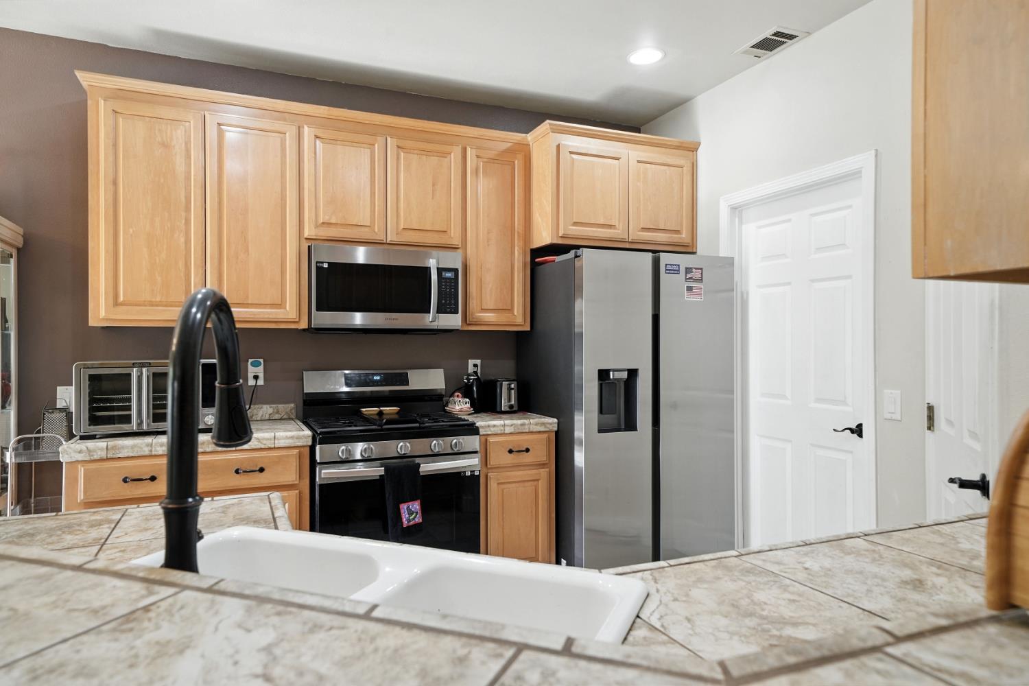 3109 Dunn Road Valley Springs, CA 95252 - Photo 56 of 62 a kitchen with granite countertop a refrigerator stove and microwave