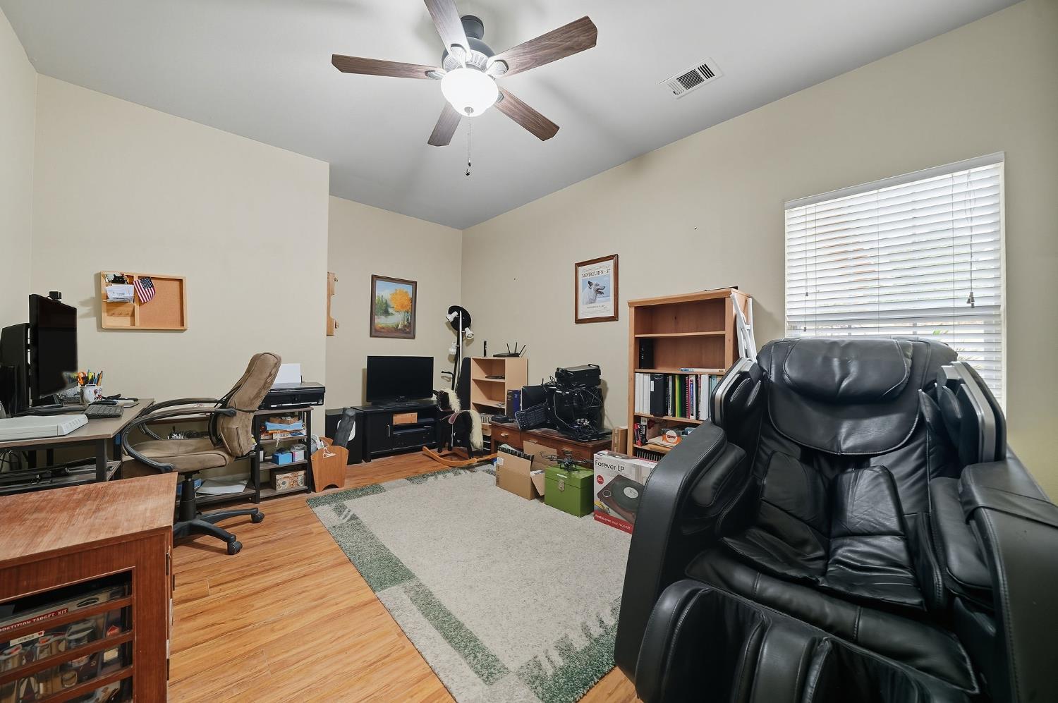 3109 Dunn Road Valley Springs, CA 95252 - Photo 61 of 62 a living room with furniture a wooden floor and a flat screen tv