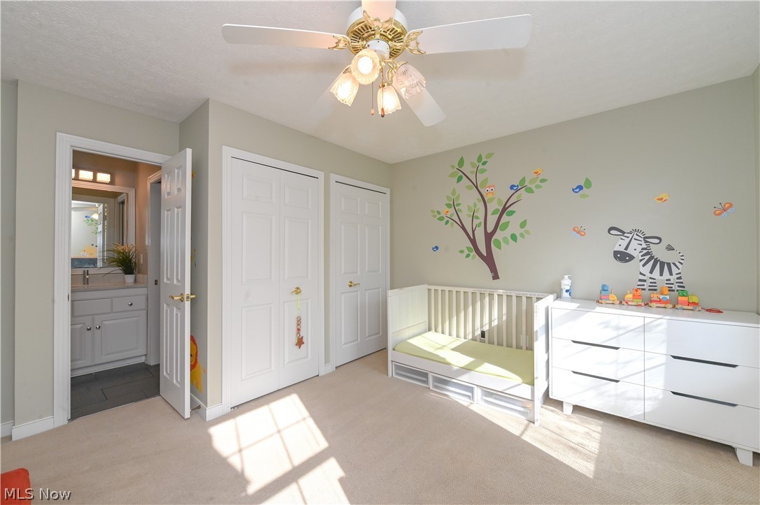 1688 Sheridan Road South Euclid, OH 44121 - Photo 24 of 48 Carpeted bedroom with ensuite bath, ceiling fan, and two closets