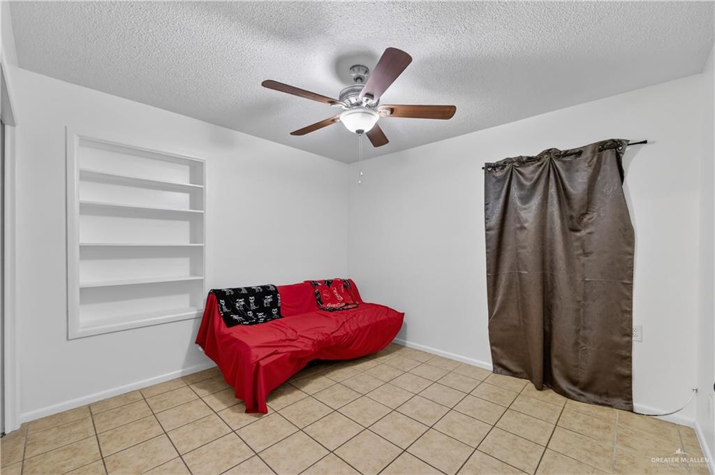 616 5th Street Weslaco, TX 78596 - Photo 31 of 33 a room with a bed and a ceiling fan