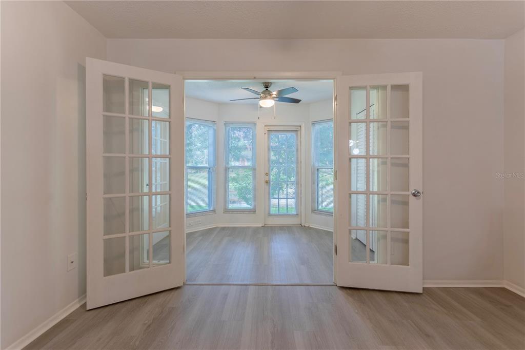 4428 Middlebrook Road, Unit 4 Orlando, FL 32811 - Photo 11 of 28 an empty room with wooden floor and windows