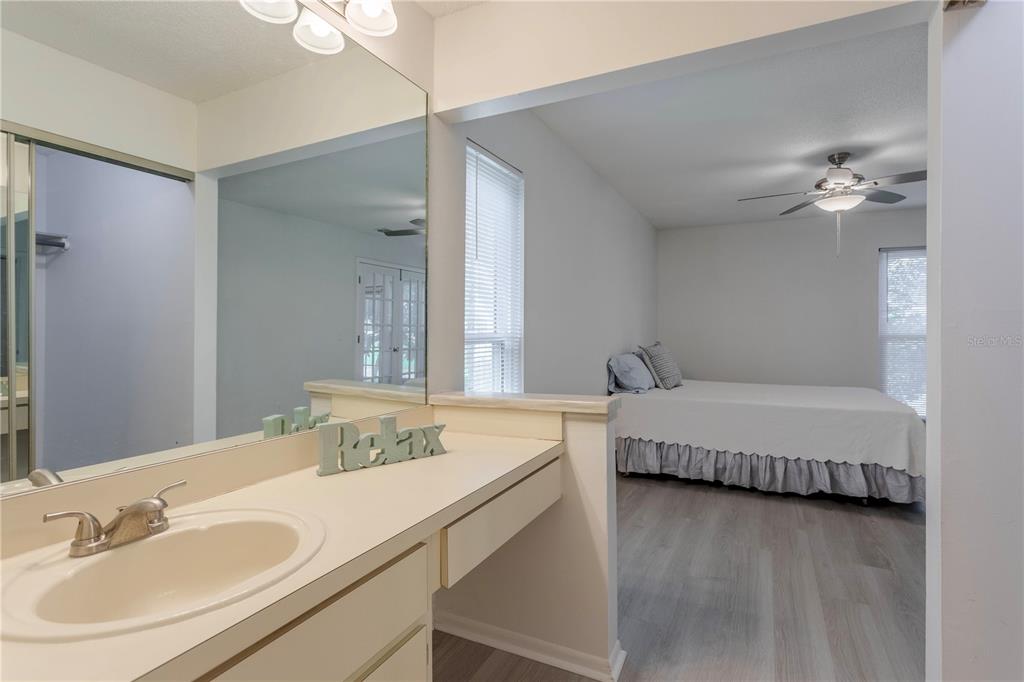 4428 Middlebrook Road, Unit 4 Orlando, FL 32811 - Photo 14 of 28 a en suite bathroom with a double vanity sink a mirror and a bathtub