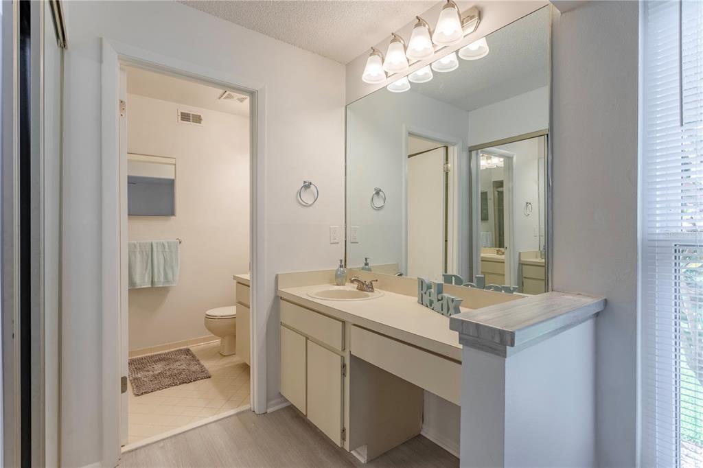 4428 Middlebrook Road, Unit 4 Orlando, FL 32811 - Photo 15 of 28 a bathroom with a sink a toilet and a mirror