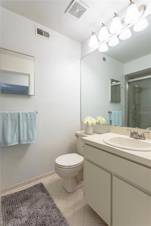 4428 Middlebrook Road, Unit 4 Orlando, FL 32811 - Photo 17 of 28 a bathroom with a sink a toilet and a mirror