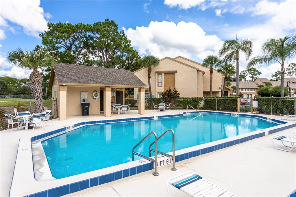 4428 Middlebrook Road, Unit 4 Orlando, FL 32811 - Photo 28 of 28 a view of a patio with swimming pool table and chairs