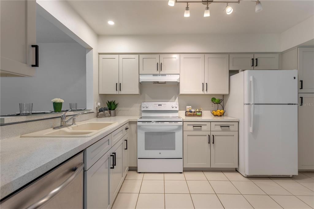 4428 Middlebrook Road, Unit 4 Orlando, FL 32811 - Photo 3 of 28 a kitchen with a white cabinets and white appliances
