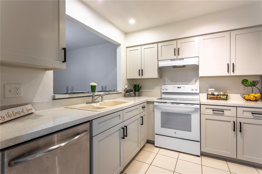 4428 Middlebrook Road, Unit 4 Orlando, FL 32811 - Photo 4 of 28 a kitchen with cabinets appliances a sink and a counter top space