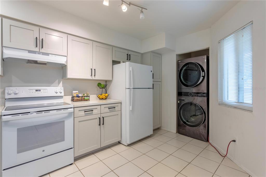4428 Middlebrook Road, Unit 4 Orlando, FL 32811 - Photo 5 of 28 a kitchen with cabinets and washer dryer