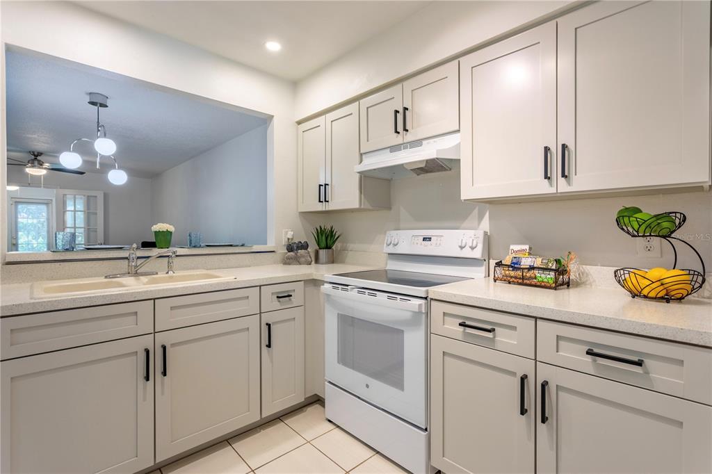 4428 Middlebrook Road, Unit 4 Orlando, FL 32811 - Photo 6 of 28 a kitchen with white cabinets and white appliances