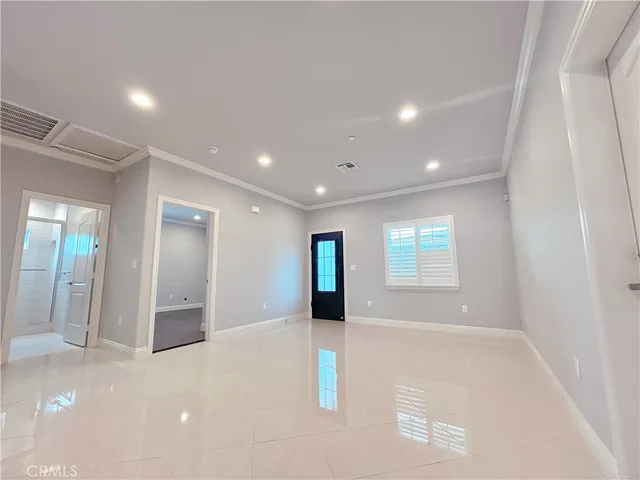 an empty room with windows and entrance