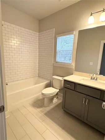 a bathroom with a sink a toilet and bathtub