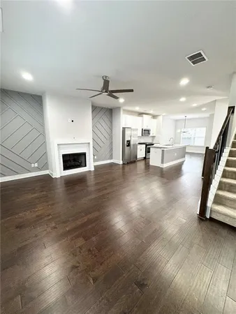 a view of empty room with wooden floor