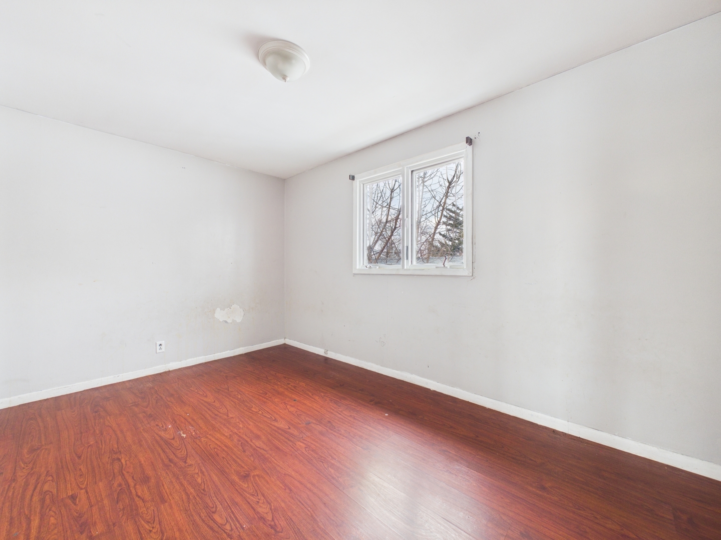 4707 West 82nd Place Chicago, IL 60652 - Photo 14 of 23 an empty room with wooden floor and windows