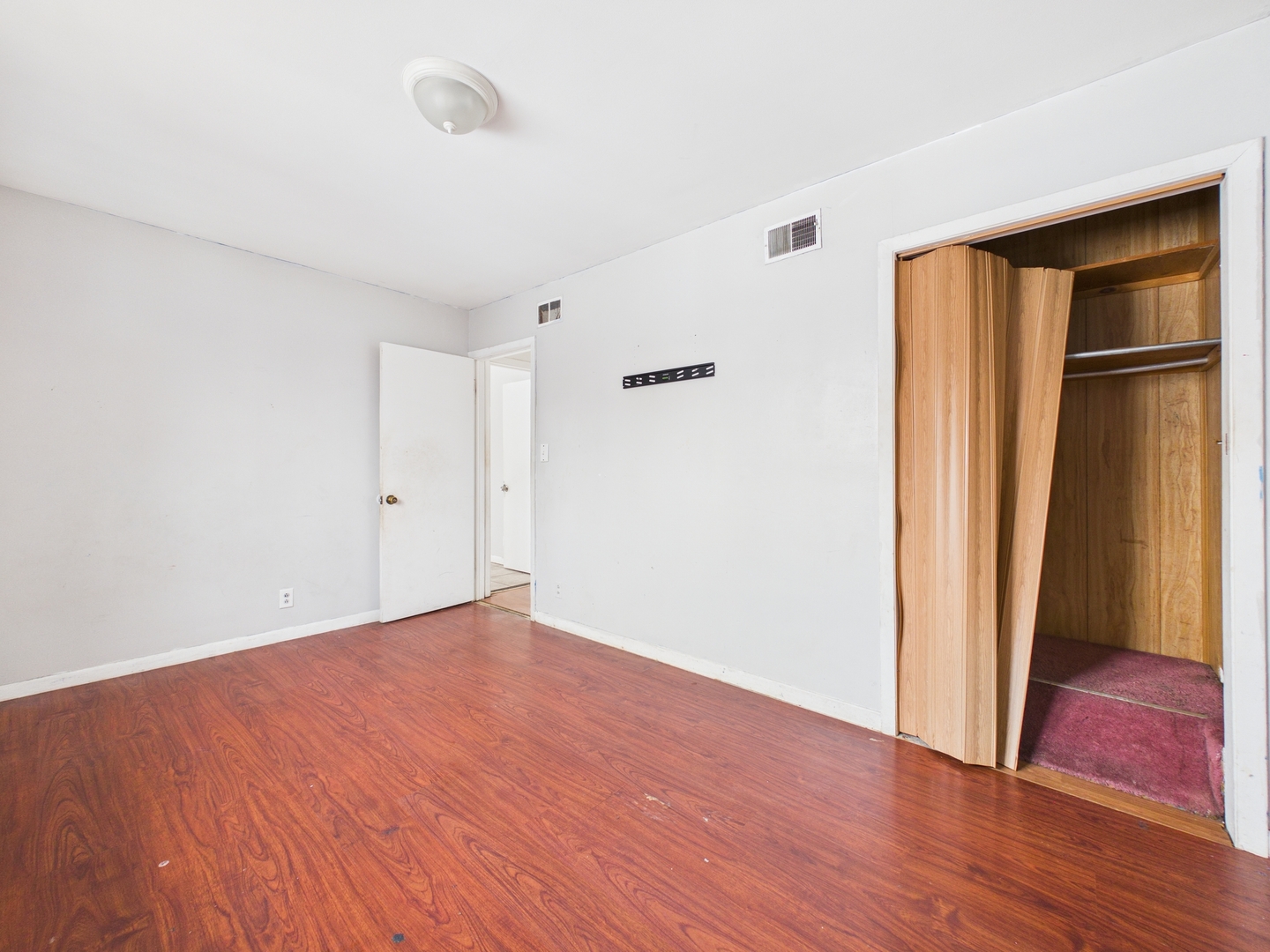 4707 West 82nd Place Chicago, IL 60652 - Photo 15 of 23 an empty room with wooden floor and closet