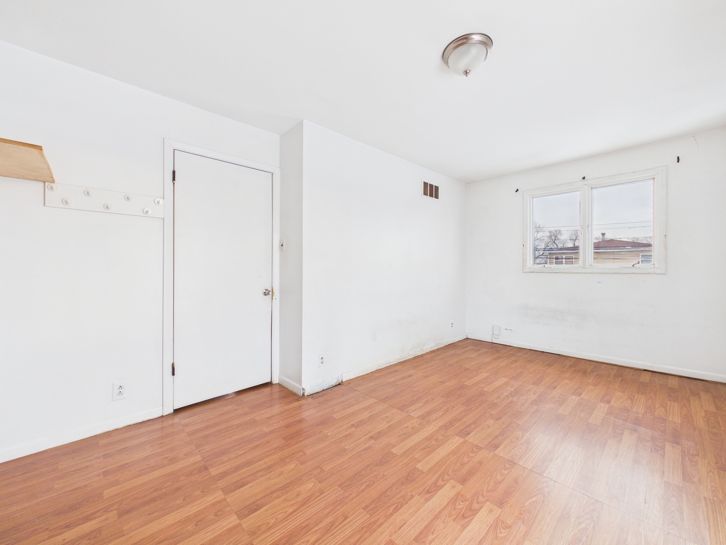 4707 West 82nd Place Chicago, IL 60652 - Photo 18 of 23 a view of empty room with wooden floor and fan
