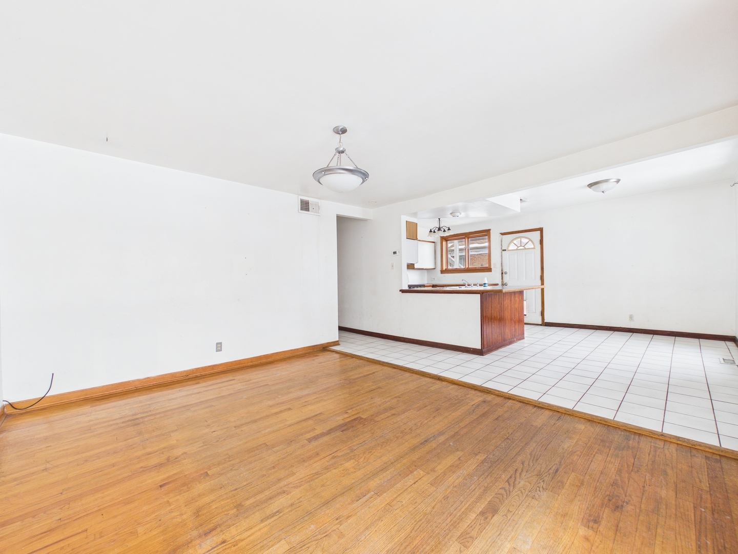 4707 West 82nd Place Chicago, IL 60652 - Photo 4 of 23 a view of a kitchen with wooden floor and windows