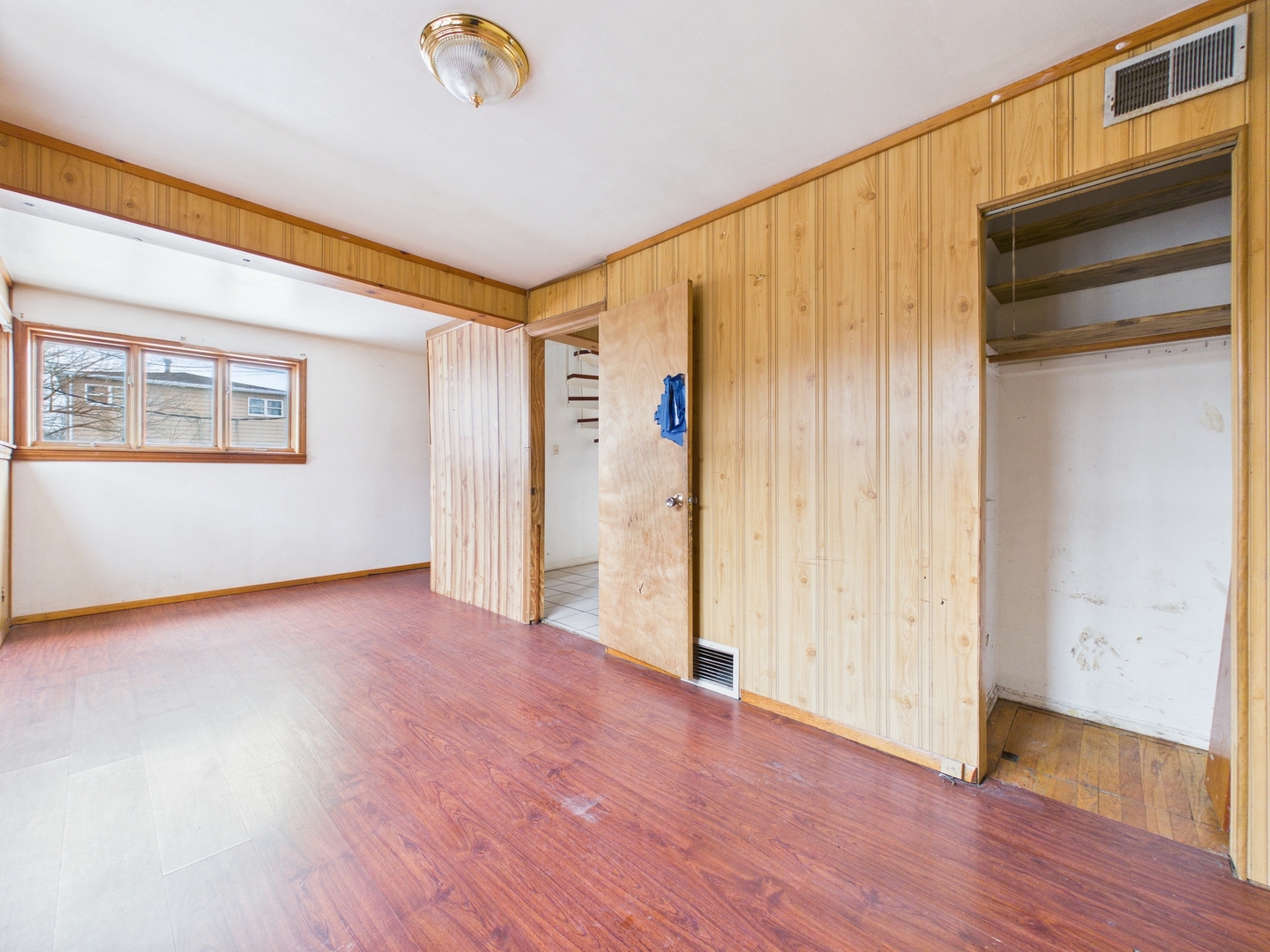 4707 West 82nd Place Chicago, IL 60652 - Photo 8 of 23 a view of an empty room with wooden floor and a window