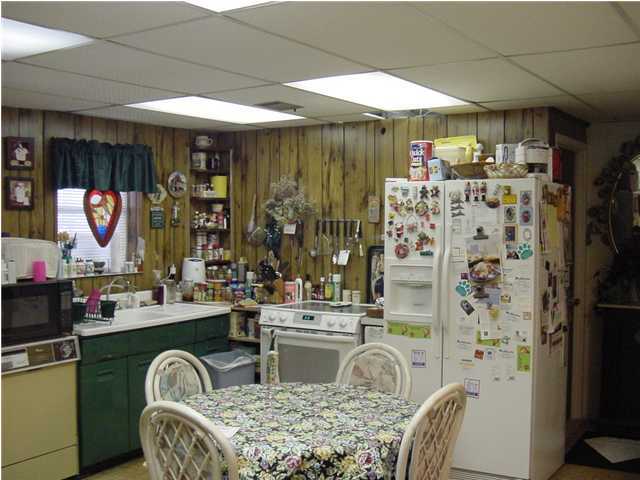 2824 Bay Grove Road Freeport, FL 32439 - Photo 6 of 15 a kitchen with a refrigerator and a table