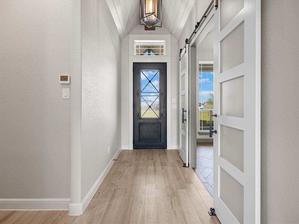 161 Frontera Drive Decatur, TX 76234 - Photo 15 of 40 a view of a hallway with wooden floor and a bathroom